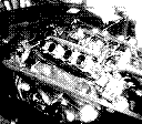 A black and white Game Boy Camera photo of a car engine